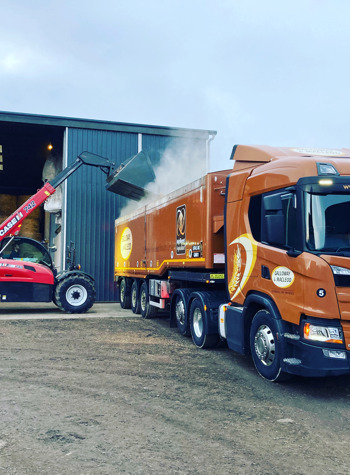 galloway and macleod lorry getting loaded by red loader at farmhouse