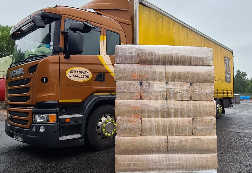 a pallet of shavings for horses in front of galloway and macleod truck