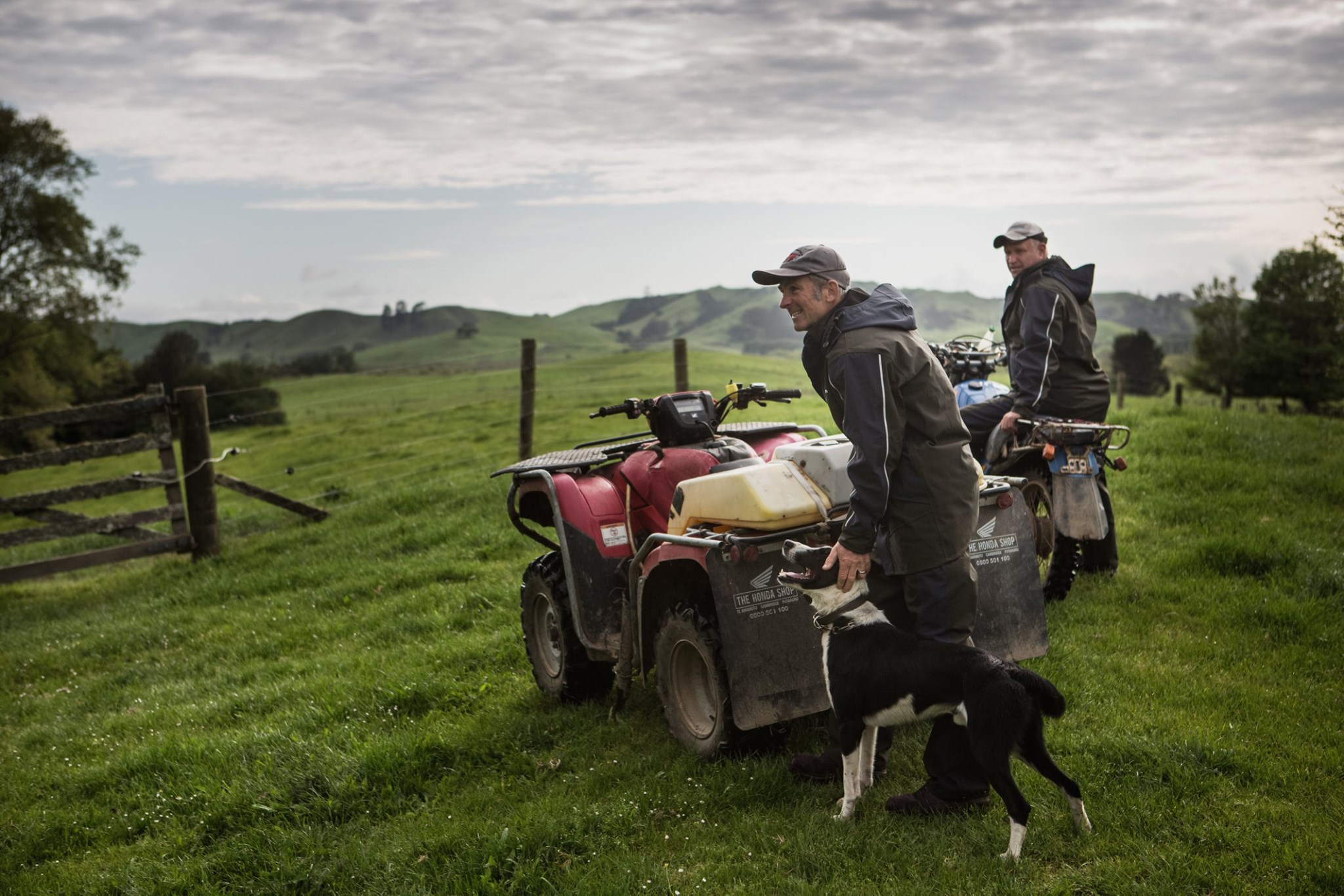 two men in field with dog and quad wearing kaiwaka farm wear
